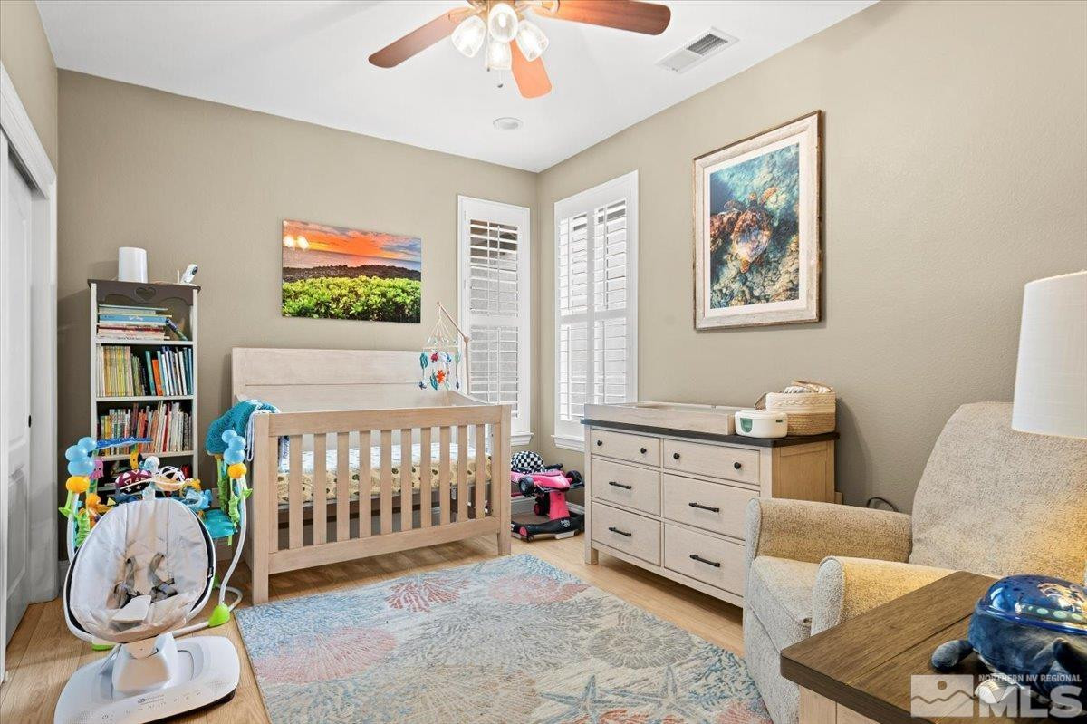 630 Equine Court Reno, NV 89521 - Photo 29 of 40 a bedroom with furniture and a baby crib