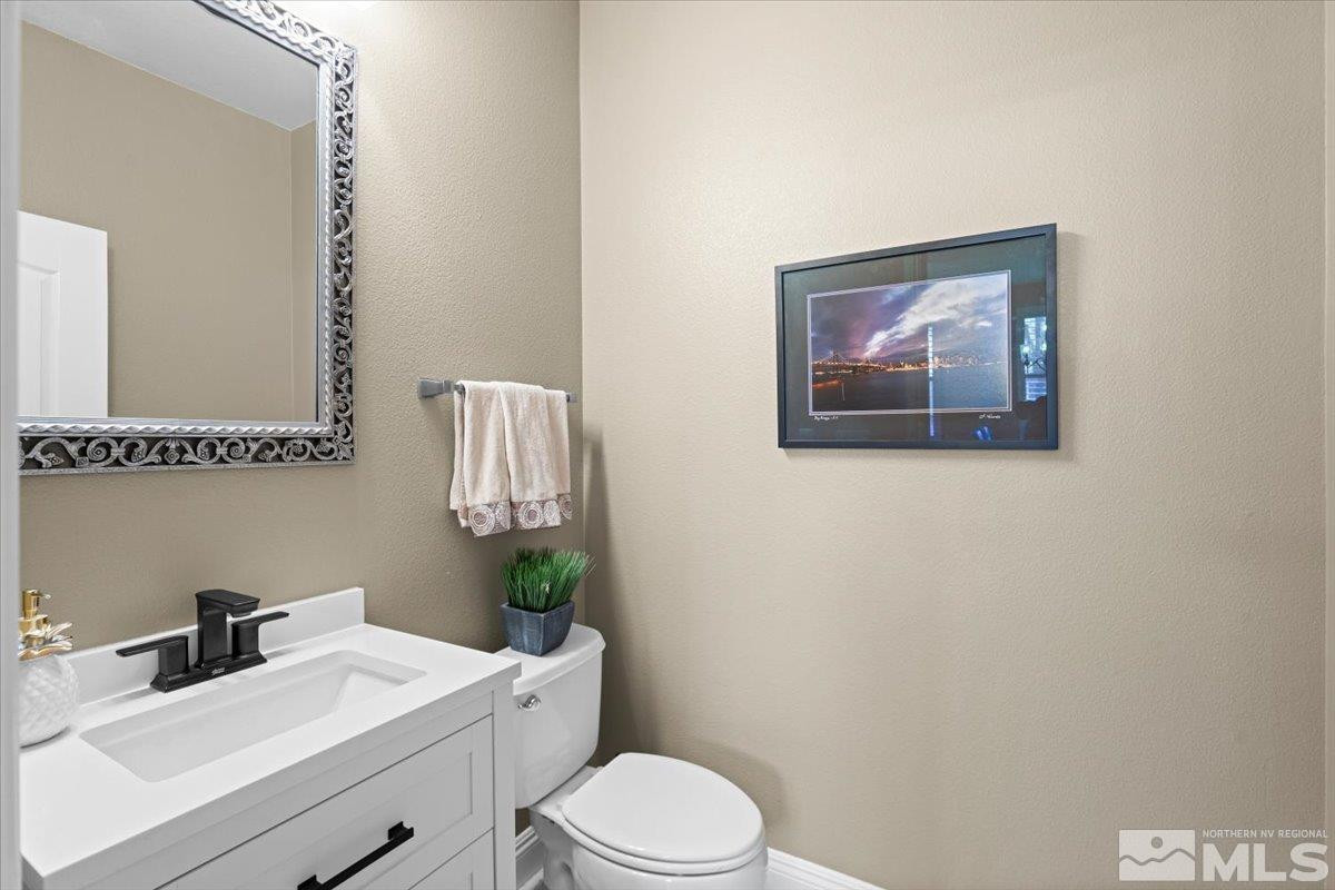 630 Equine Court Reno, NV 89521 - Photo 30 of 40 a bathroom with a toilet a sink and mirror