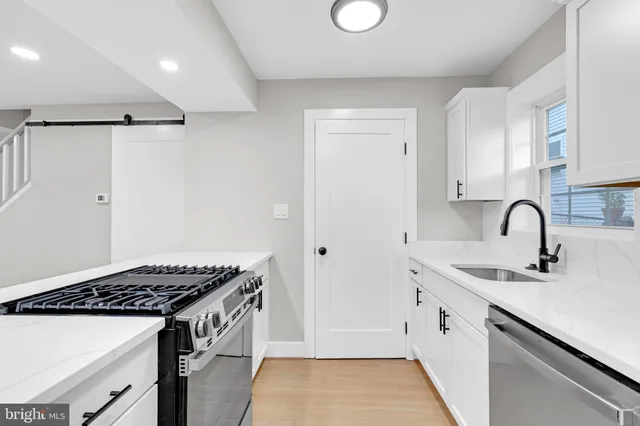 a kitchen that has a sink and a stove
