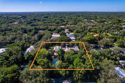 an aerial view of a residential houses with outdoor space and swimming pool