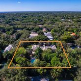 an aerial view of a residential houses with outdoor space and swimming pool
