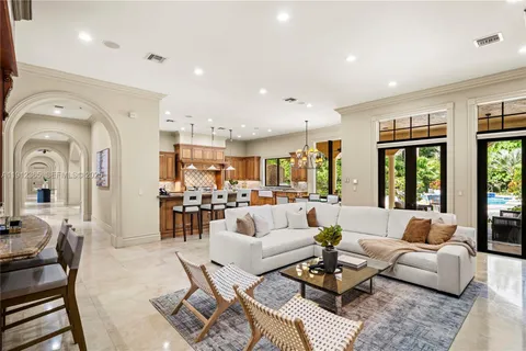 a living room with furniture fireplace and large windows