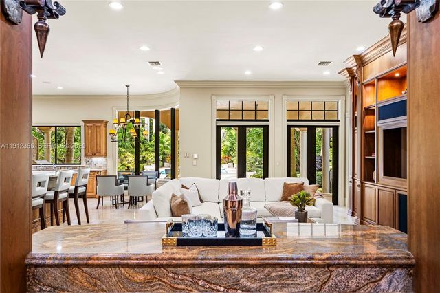 a view of a dining room with furniture a chandelier and wooden floor
