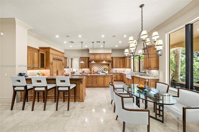 a large kitchen with a table and chairs
