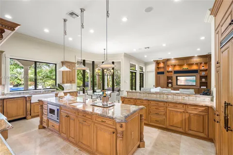 a large kitchen with kitchen island a large counter top appliances and a center island