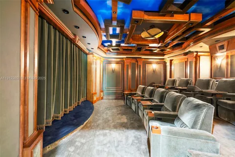 a media room with lots of chairs and a chandelier