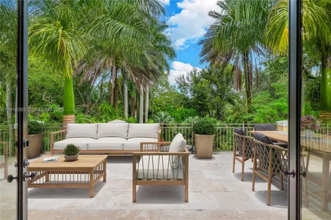 a view of a patio with couches and potted plants