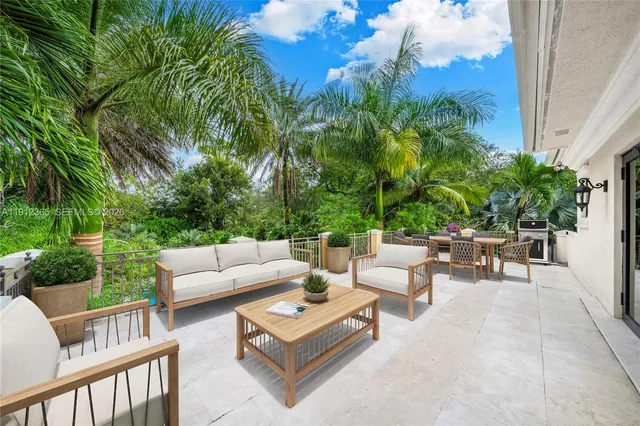 a swimming pool with outdoor seating and yard