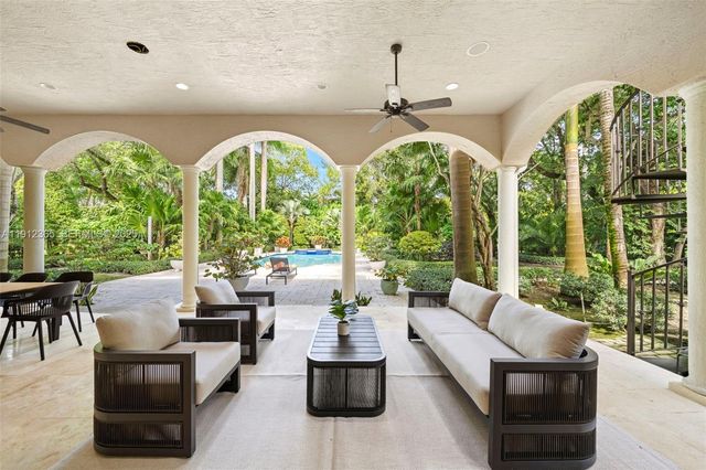 a living room with large windows and furniture