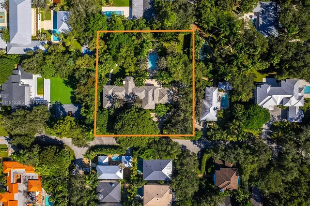 a view of a patio with table and chairs and a large tree