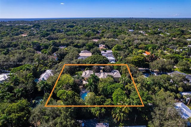 a view of a patio with table and chairs and a large tree