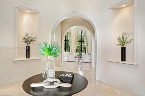 a dining room with furniture potted plants and wooden floor