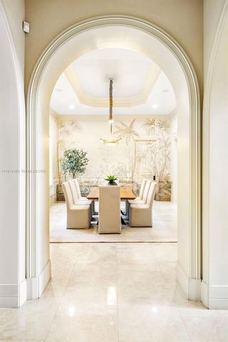 a view of a living room with a floor to ceiling window and front door