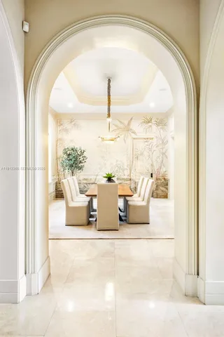 a view of a living room with a floor to ceiling window and front door