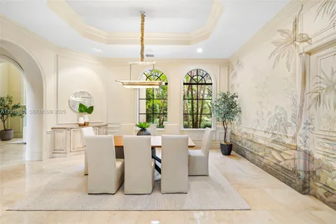 a living room with fireplace furniture and a large window