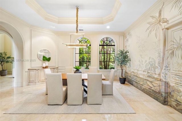 a living room with fireplace furniture and a large window