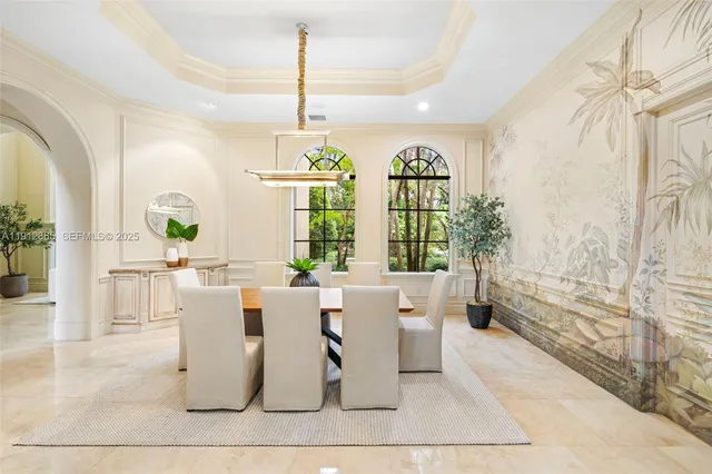 a living room with fireplace furniture and a large window