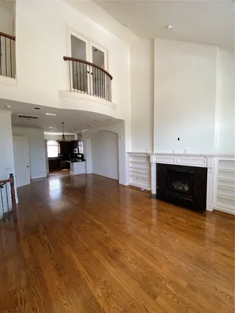 a view of kitchen and hall with wooden floor