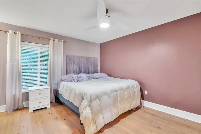 a large bed sitting in a room next to a window