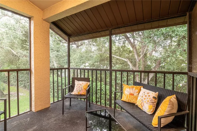 a living room with furniture and a floor to ceiling window