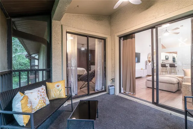 a living room with furniture and a floor to ceiling window