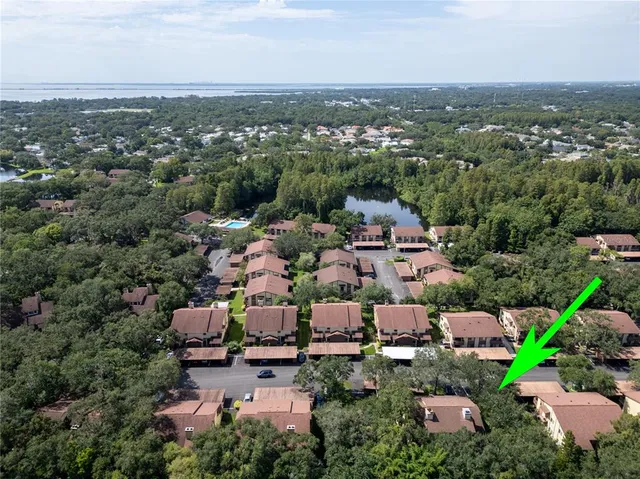 an aerial view of a houses with a yard