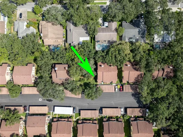 an aerial view of multiple houses with yard