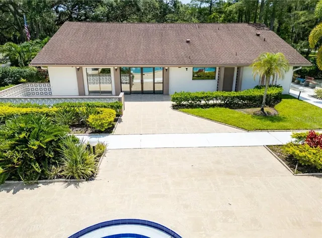 a front view of a house with a garden and plants