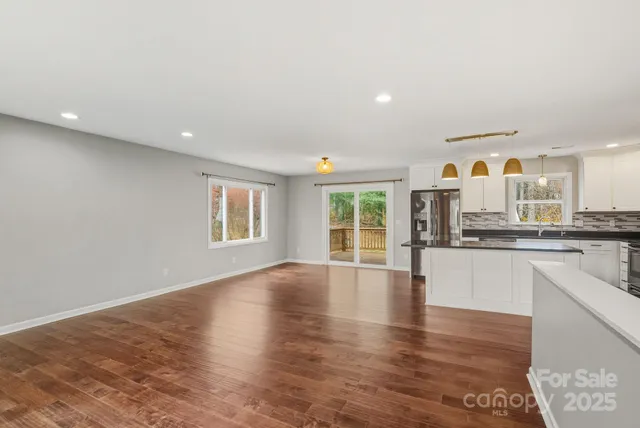 a view of large kitchen with granite countertop cabinets and wooden floor