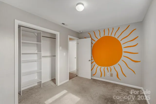 a view of a room with wooden floor and a sink