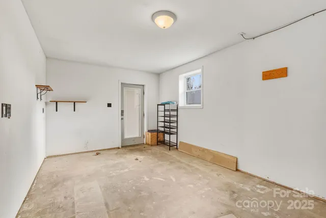 an empty room with closet and windows