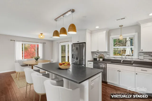a kitchen with a sink a counter space and living room