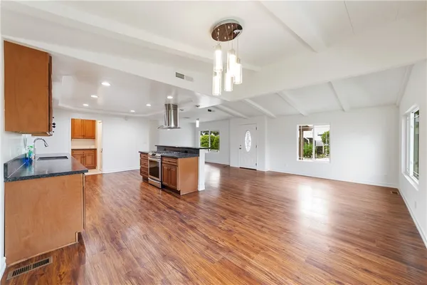 a view of kitchen with cabinets and wooden floor