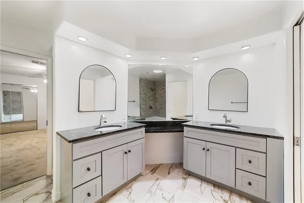 a bathroom with a granite countertop sink mirror and