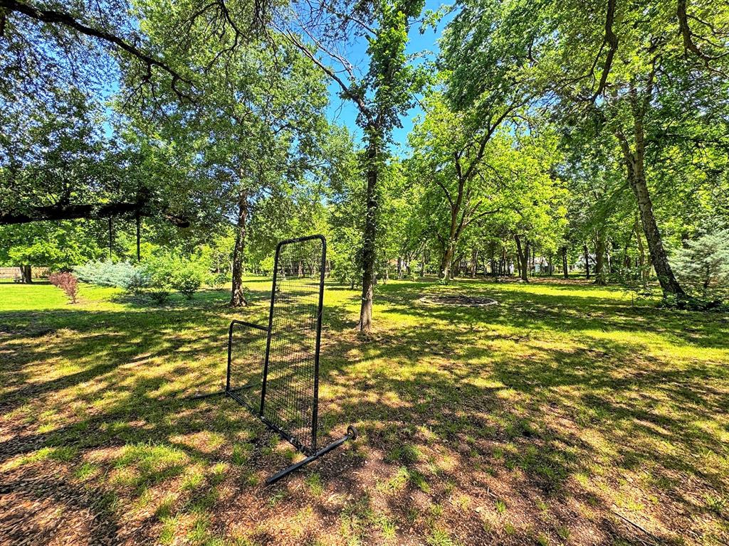 406 Griffith Avenue Terrell, TX 75160 - Photo 39 of 40 Spacious outdoor area featuring mature trees and lush green grass
