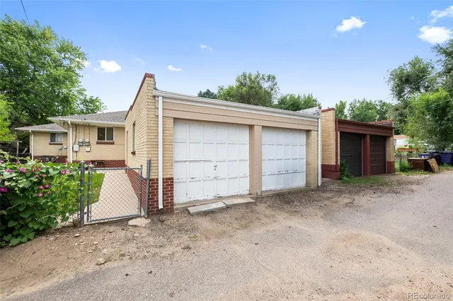 front view of a house with a yard and a garage