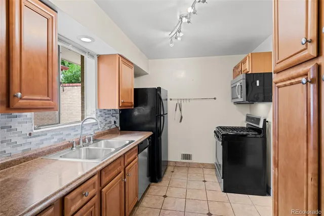 a kitchen with a sink a stove and refrigerator