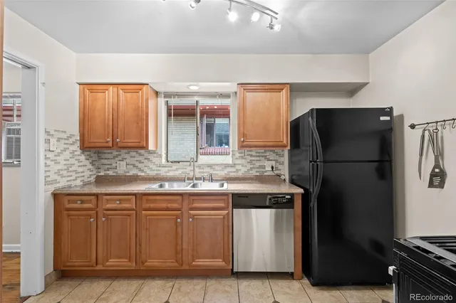 a kitchen with a sink and a refrigerator