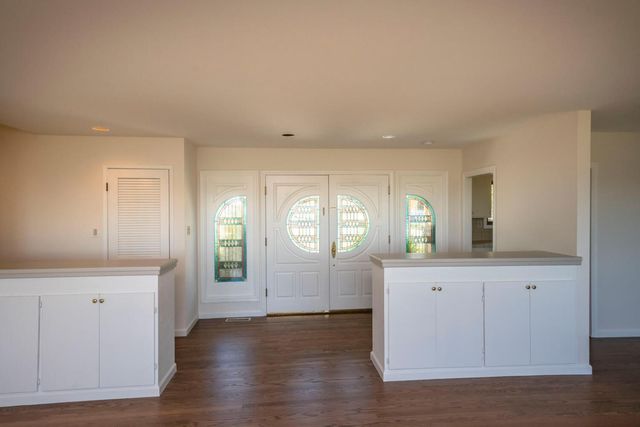 a view of a kitchen cabinets and a wooden floor