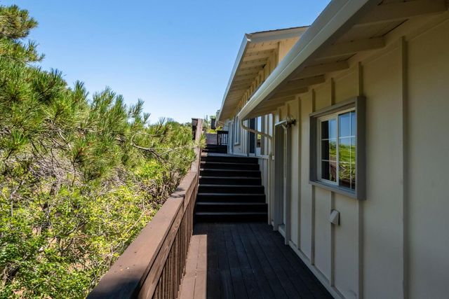 a view of a balcony with wooden floor and fence