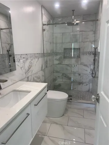 a bathroom with a toilet and a shower