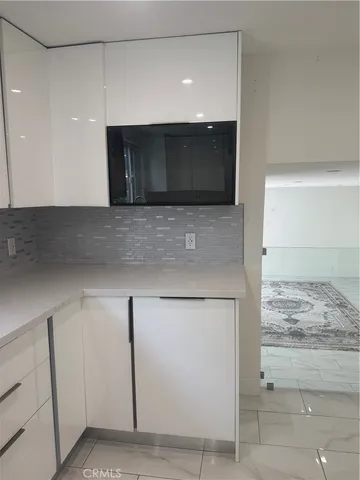 a stove top oven sitting inside of a kitchen