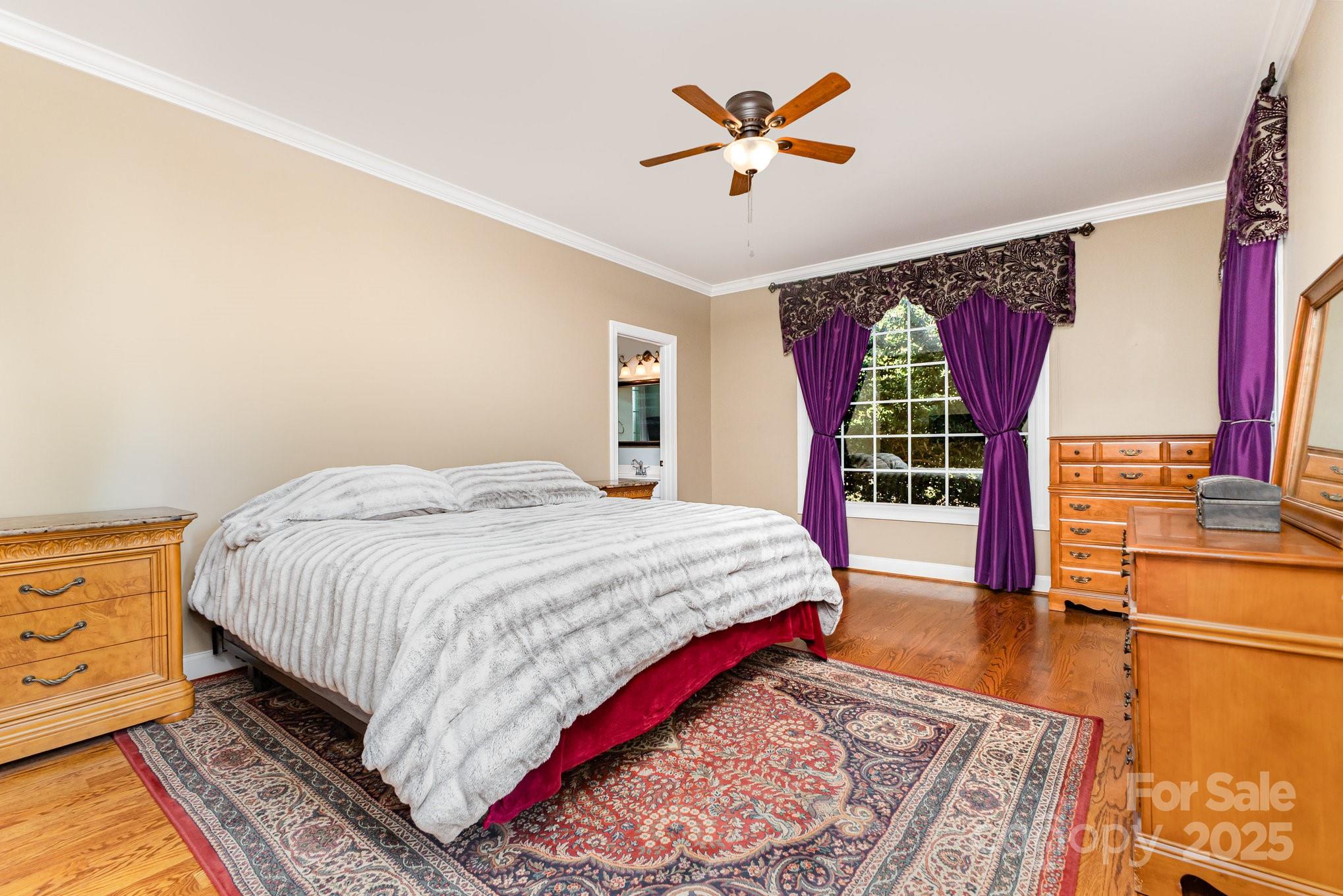 2227 Nash Road Wingate, NC 28174 - Photo 17 of 40 a spacious bedroom with a bed and a chandelier