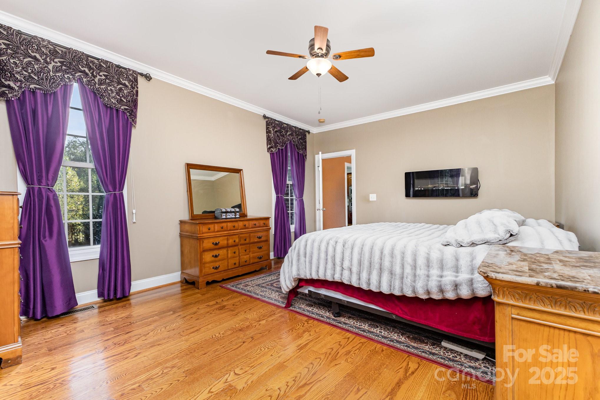 2227 Nash Road Wingate, NC 28174 - Photo 18 of 40 a bedroom with a bed and a chandelier
