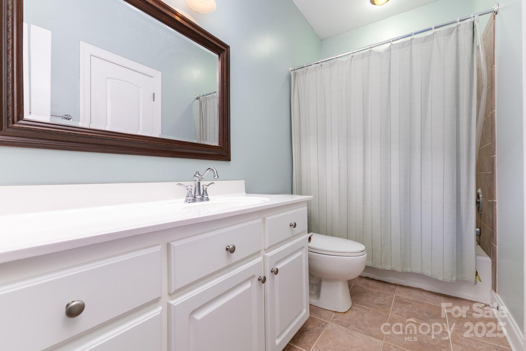 2227 Nash Road Wingate, NC 28174 - Photo 23 of 40 a bathroom with a sink a toilet and a mirror