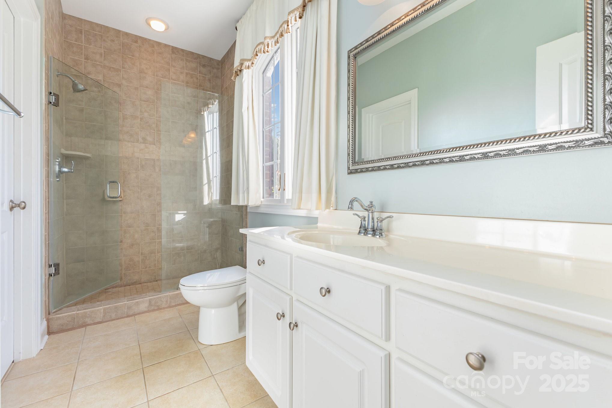 2227 Nash Road Wingate, NC 28174 - Photo 26 of 40 a bathroom with a double vanity sink toilet and shower