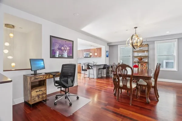 a view of a dining room with furniture window and wooden floor