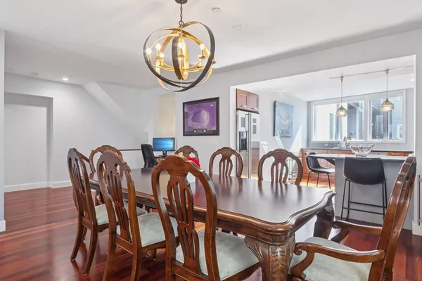 a view of a dining room with furniture and chandelier
