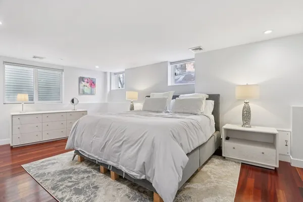 a spacious bedroom with a bed and a window