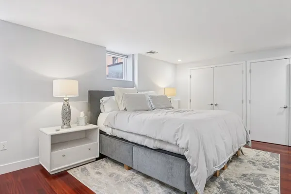 a bedroom with a bed and a night stand
